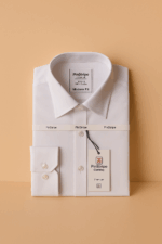 A crisp, folded white long-sleeve men's dress shirt with a visible collar, buttons, and a brand tag on the sleeve, presented on a light background.