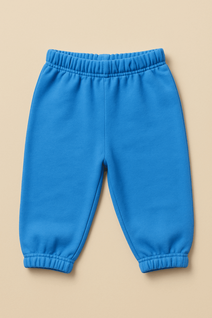 A plain blue baby joggers or sweatpants with an elasticated waistband and cuffed ankles
