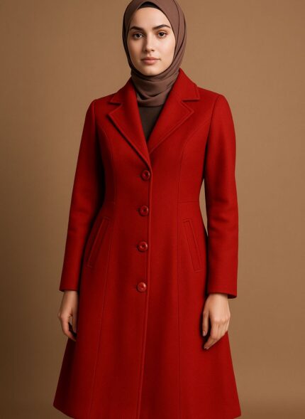 Woman wearing a red coat and hijab.