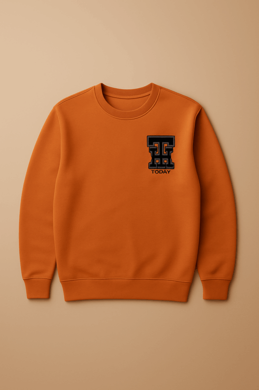 An orange Tommy Hilfiger crewneck sweatshirt with a navy blue embroidered "TH" logo on the left chest.