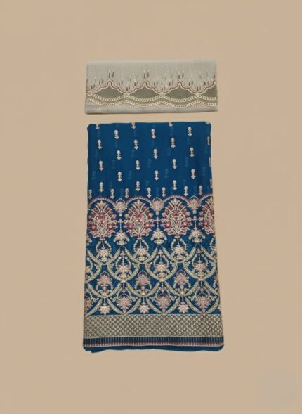 Unstitched deep teal (blue-green) formal suit fabric with elaborate gold, pink, and red traditional embroidery patterns on the lower half, and a separate light grey-green dupatta piece with scalloped cutwork and embroidery.