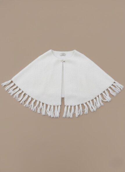 White Knit Fringe Cape Sweater with front button closure and decorative fringe detailing on a neutral background.