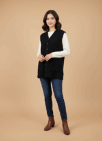 Women's black cable knit sweater vest with buttons and pockets on a beige background