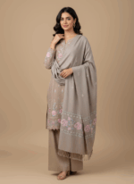 Hand-embroidered pashmina shawl with pink and blue floral embroidery on a beige background and fringed edges.