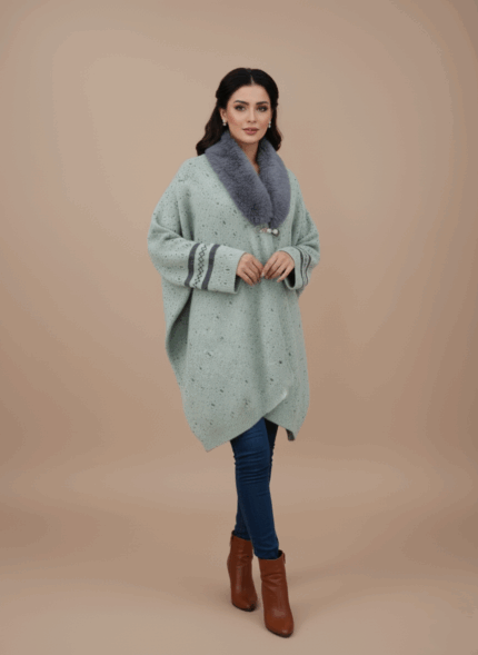 Mint green women's knit sweater with a grey faux fur collar and dark patterned accents.