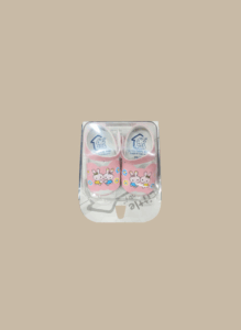 Pink bunny baby shoes for newborns with cartoon design in packaging.