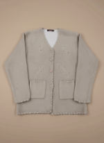 Light beige women's button-front sweater with decorative embroidery, two front pockets, and scalloped edges on a neutral background.