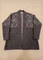 Women's dark gray open-front alpaca sweater with light gray geometric knit patterns and a decorative pin.