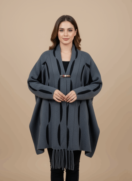 Women's grey kimono sweater with black wave pattern and fringe, front view, open-front knit, toggle closure.