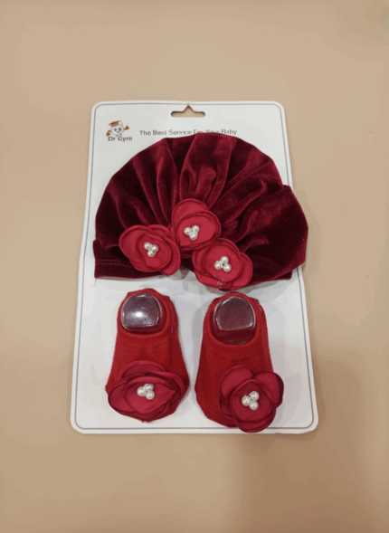 Red baby headband and socks set with floral pearl design on soft cotton fabric for newborns.