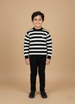 Young boy smiling, wearing a black and white striped sweater and black pants, showcasing a comfortable kids striped sweater.