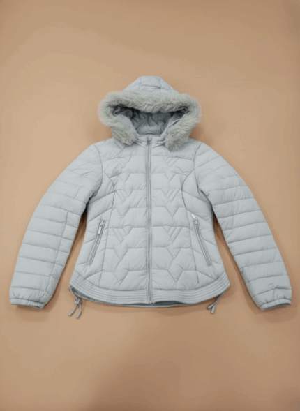 Light grey women's hooded puffer jacket with faux fur trim, quilted design, and zippered pockets.