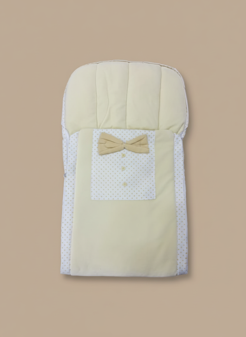 Soft beige baby sleeping bag with bow and polka dot design made of cotton for newborn comfort and warmth.