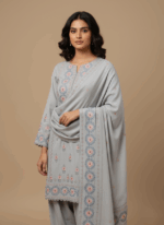 "Soft grey embroidered shawl with detailed pink and blue floral and leaf embroidery, folded neatly against a light background."