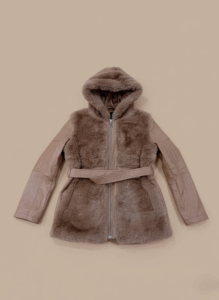 Women's hooded faux fur and leather belted jacket with brown faux fur body and brown leather sleeves on a light background.