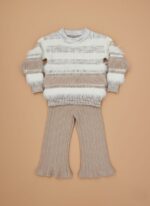 Smiling girl wearing a beige and white fuzzy knit sweater set for winter.