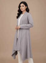 Women's knit sweater with a textured open-front design and a decorative brooch at the collar, in a neutral color.