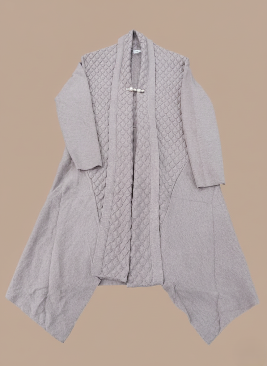 Women's knit sweater with a textured open-front design and a decorative brooch at the collar, in a neutral color.