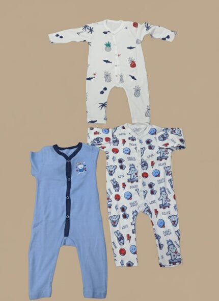 Three different baby rompers displayed on a neutral background, including a white patterned long-sleeve romper, a blue short-sleeve romper with an embroidered bear, and a white patterned long-sleeve baby romper.