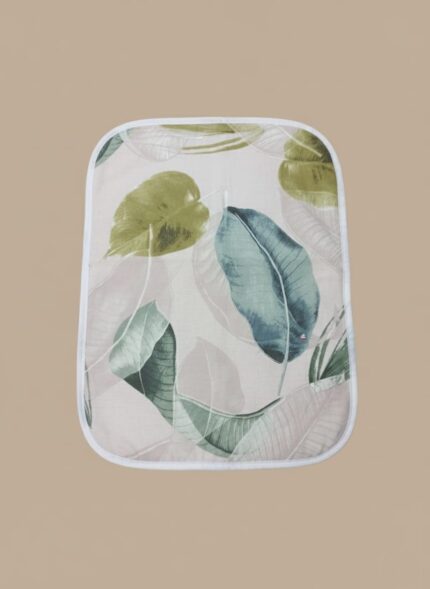 A rectangular portable baby changing mat with rounded corners, displaying a tropical leaf print in various green and blue hues on a light background.