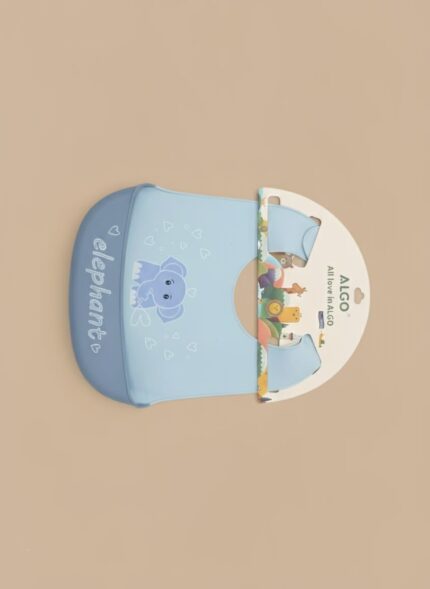 A light blue silicone baby bib, packaged for display, featuring a cartoon elephant graphic and text, with a built-in pocket to catch food.
