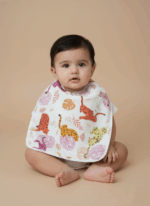 A white cotton baby bib with a vibrant pattern of colorful leopards and tropical leaves.