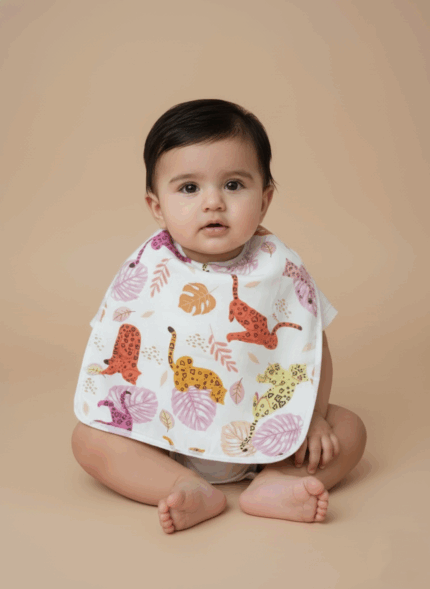 A white cotton baby bib with a vibrant pattern of colorful leopards and tropical leaves.