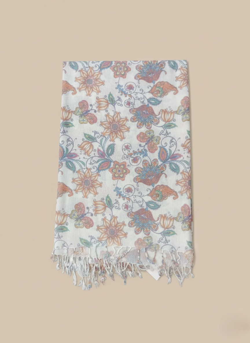 White floral print pashmina shawl with peach, teal, and blue flowers and butterflies, laid flat on a light background.