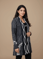 Women's black and white patterned open-front sweater with long sleeves and a prominent decorative link design down the center. The sweater features geometric and stripe patterns, perfect for a stylish women's sweater collection.