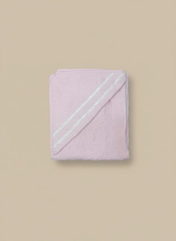 A folded pink baby hooded towel with white stripes on the hood, made from a plush, soft fabric.