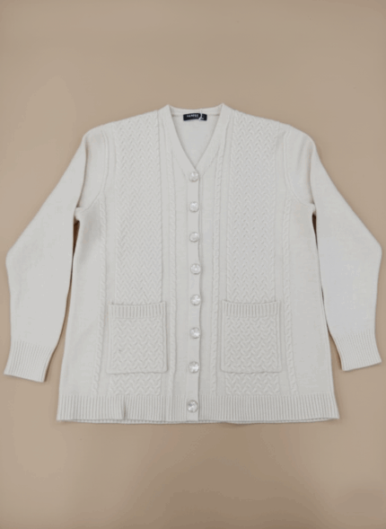 Beige women's V-neck cable knit sweater with button front and two front pockets.