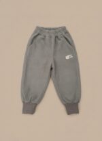 A pair of grey ribbed baby pants with a bear embroidery on the pocket, an elastic waist, and cuffed ankles.