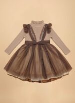 Toddler wearing brown girls party dress with ruffled shoulders and tulle skirt.