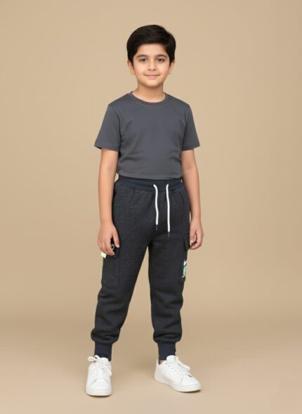 Kid wearing dark grey boys cargo jogger pants styled with a t-shirt and sneakers.