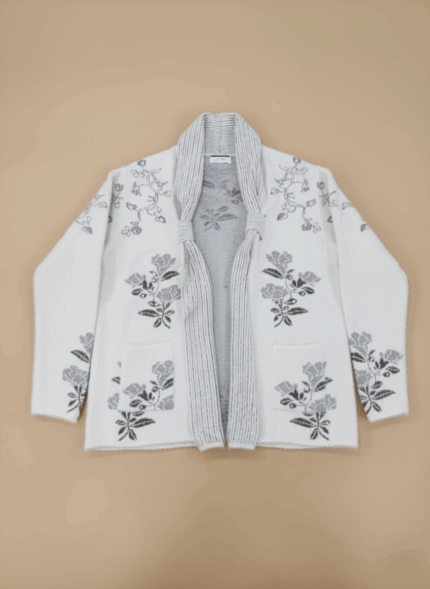 Women's elegant ivory floral knit cardigan sweater with grey embroidered flowers and an open front, displayed on a neutral background.
