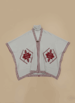 Light grey women's embroidered poncho sweater with burgundy geometric design and border on a light brown background.