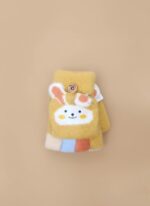 A close-up of a pair of yellow kids bunny mittens with a white bunny face appliqué and small 3D ears. The mittens have a convertible flap secured by a button and feature colorful striped cuffs.