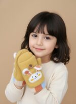 A close-up of a pair of yellow kids bunny mittens with a white bunny face appliqué and small 3D ears. The mittens have a convertible flap secured by a button and feature colorful striped cuffs.