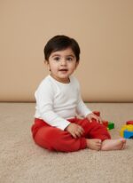 A single pair of bright red toddler fleece pants with an elastic waistband and ribbed cuffs, laid flat on a neutral background.
