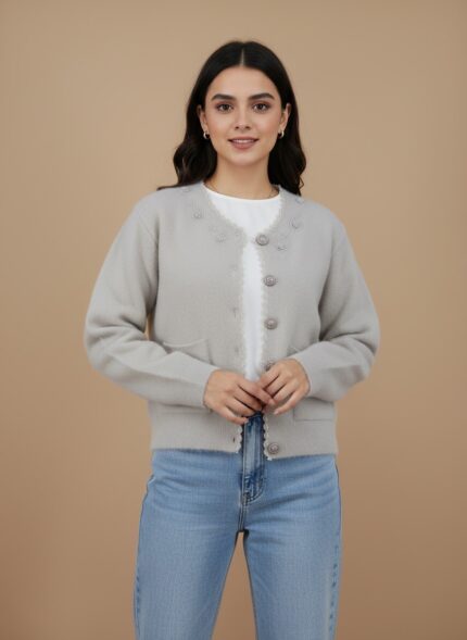 Elegant women's beige button-front sweater with embroidered details and front pockets, displayed flat on a neutral background.