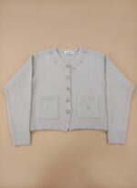 Elegant women's beige button-front sweater with embroidered details and front pockets, displayed flat on a neutral background.