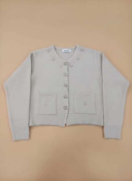 Elegant women's beige button-front sweater with embroidered details and front pockets, displayed flat on a neutral background.