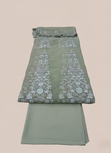 ALTAN Virsa Emerald Luxury Wedding Collection Embroidered Net Suit in emerald green, with intricate light blue and silver embroidery on net kali, sheer embroidered net sleeves, and a matching embroidered dupatta, worn by a female model.