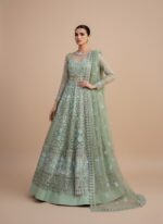 ALTAN Virsa Emerald Luxury Wedding Collection Embroidered Net Suit in emerald green, with intricate light blue and silver embroidery on net kali, sheer embroidered net sleeves, and a matching embroidered dupatta, worn by a female model.
