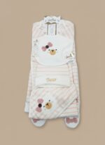 Lay-flat studio shot of the complete "Baby Bear" starter outfit set, showing a pink and white striped long-sleeve jumpsuit, matching hat, and bear-face bib, laid out neatly.