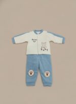 Baby wearing a cream and blue sweater with a bear and "Hello Baby!" text, paired with matching blue pants featuring paw print knee patches.