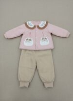 A happy baby sitting and looking at the camera, dressed in a pink long-sleeve sweater featuring a white Peter Pan collar with floral embroidery and a brown ruffled edge, two decorative pockets with plaid bows, and beige corduroy pants. This is the Baby Peter Pan Collar Sweater Set.