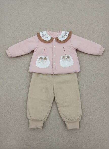 A happy baby sitting and looking at the camera, dressed in a pink long-sleeve sweater featuring a white Peter Pan collar with floral embroidery and a brown ruffled edge, two decorative pockets with plaid bows, and beige corduroy pants. This is the Baby Peter Pan Collar Sweater Set.