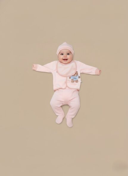 Pink baby girl clothes set with teddy bear design, including a long-sleeve shirt, two pairs of pants, a hat, and a bib, on a neutral background.
