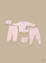 Pink baby girl clothes set with teddy bear design, including a long-sleeve shirt, two pairs of pants, a hat, and a bib, on a neutral background.